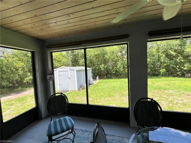 Sunroom featuring wood ceiling