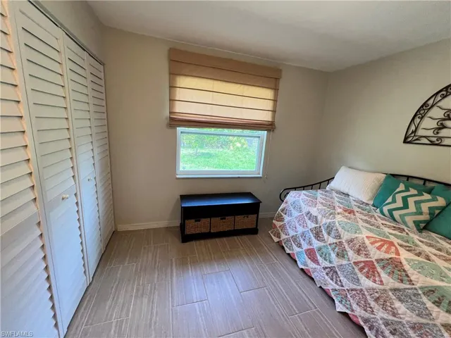 Unfurnished bedroom with a closet and hardwood / wood-style flooring