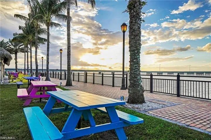 View of home's community featuring a water view and a lawn
