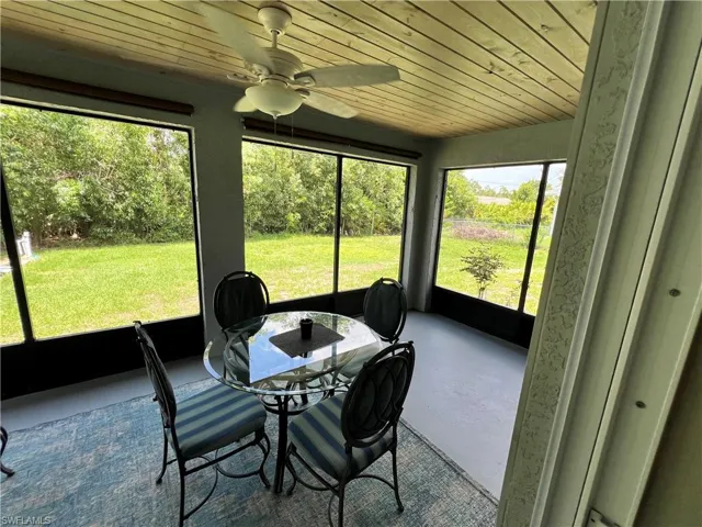 Sunroom / solarium with wood ceiling and ceiling fan