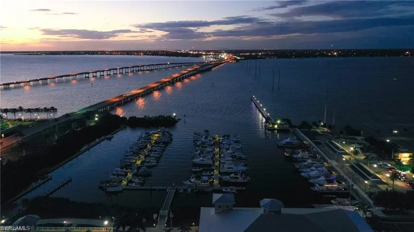 Aerial view at dusk featuring a water view