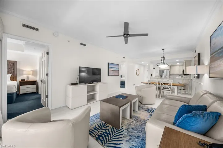 Living room featuring crown molding and ceiling fan