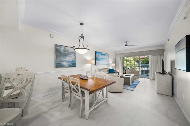 Dining room with crown molding and a ceiling fan