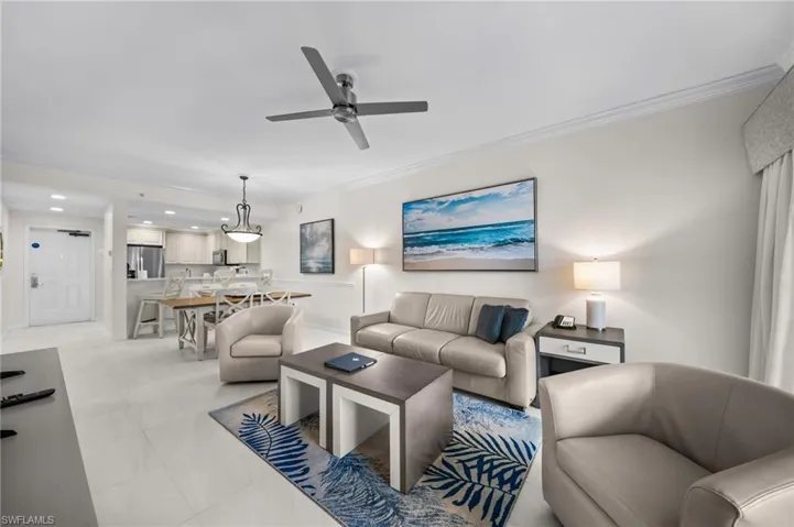 Living area featuring recessed lighting, ornamental molding, ceiling fan, and light tile patterned floors