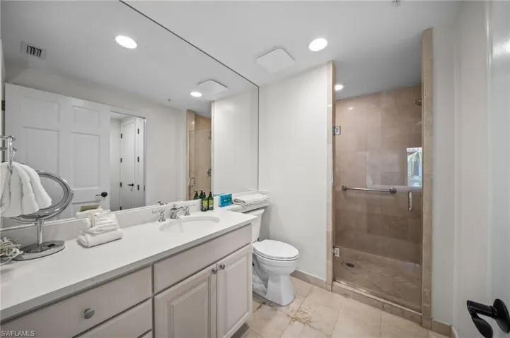 Full bathroom featuring a stall shower, vanity, and recessed lighting
