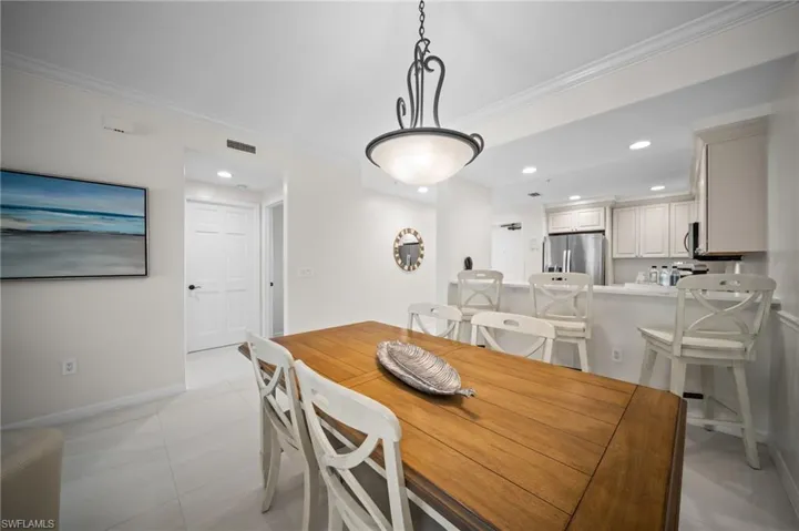 Dining room featuring ornamental molding and recessed lighting