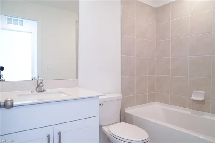 Bathroom with vanity and tub / shower combination