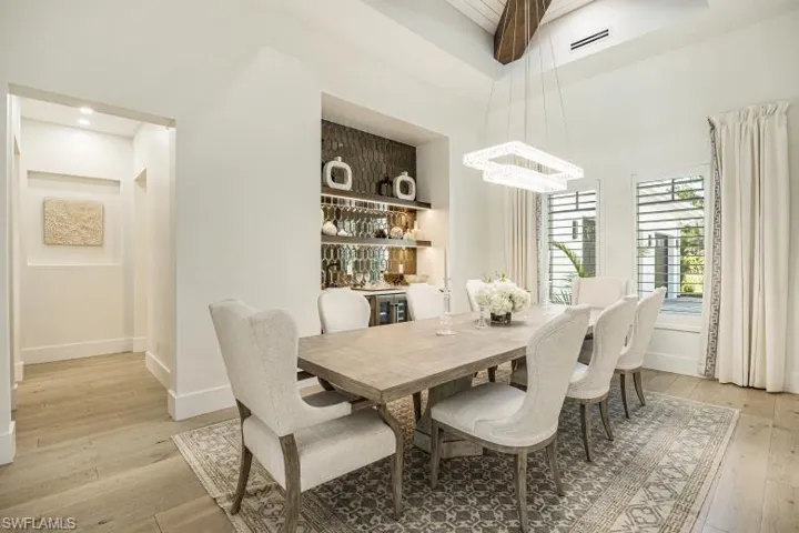 Dining area with light wood-style floors, baseboards, and a chandelier