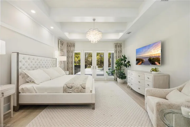 Master Bedroom featuring french doors, access to outside, light wood-style floors, a chandelier, and recessed lighting