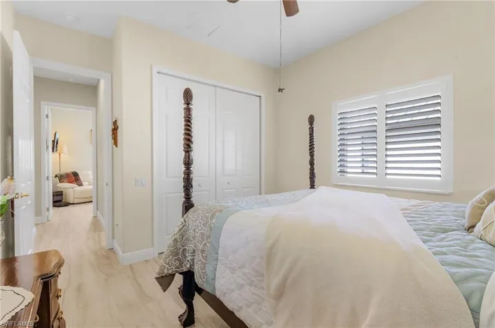 Bedroom featuring a closet, light wood-type flooring, and ceiling fan