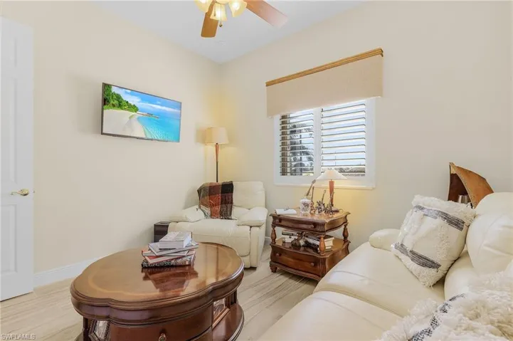 Living room featuring ceiling fan and light hardwood / wood-style floors