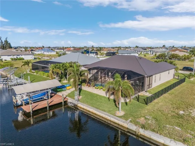 Dock area with a lawn, a lanai, and a water view