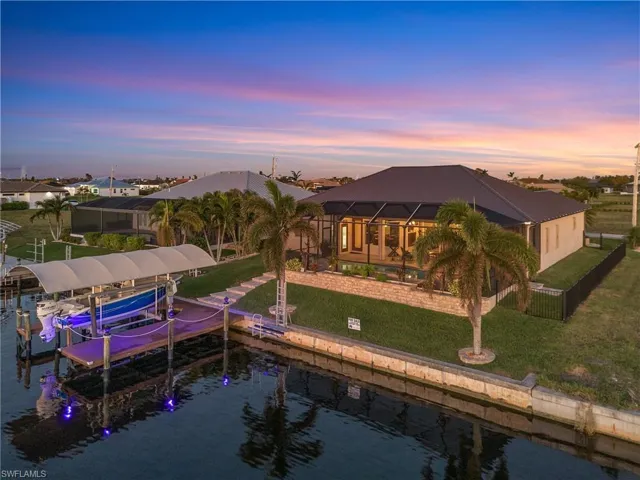 Dock area with a lawn, a lanai, and a water view