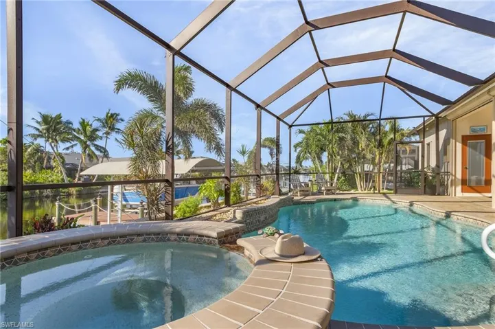 View of pool with an in ground hot tub