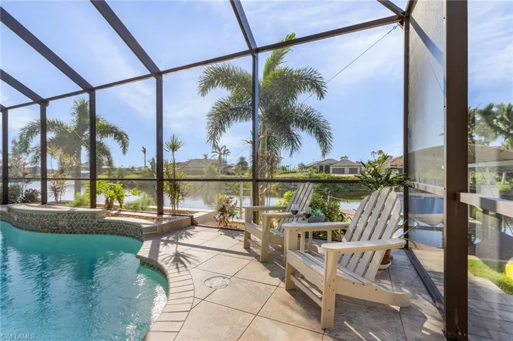 View of pool with a lanai, a water view, and a patio area