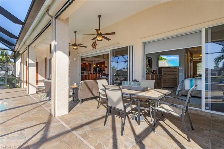 View of patio / terrace featuring a lanai and ceiling fan
