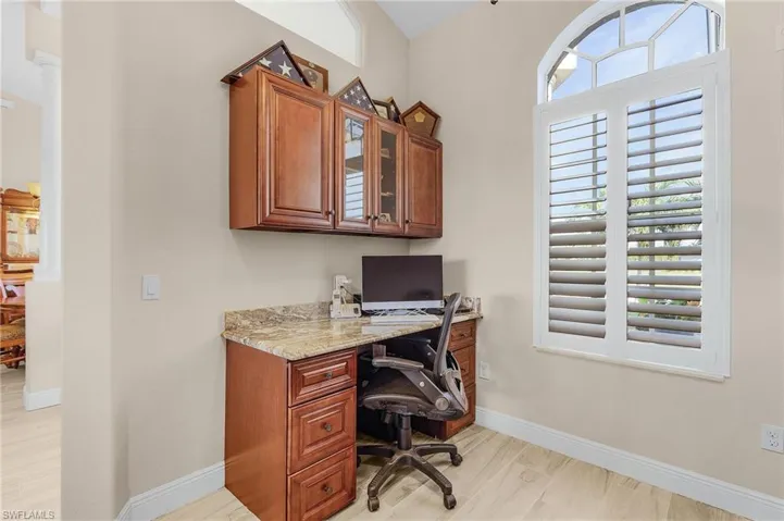 Office space with light hardwood / wood-style flooring