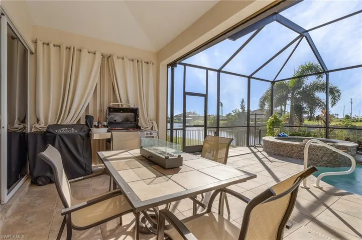 View of patio / terrace featuring a pool with hot tub, a lanai, and a water view