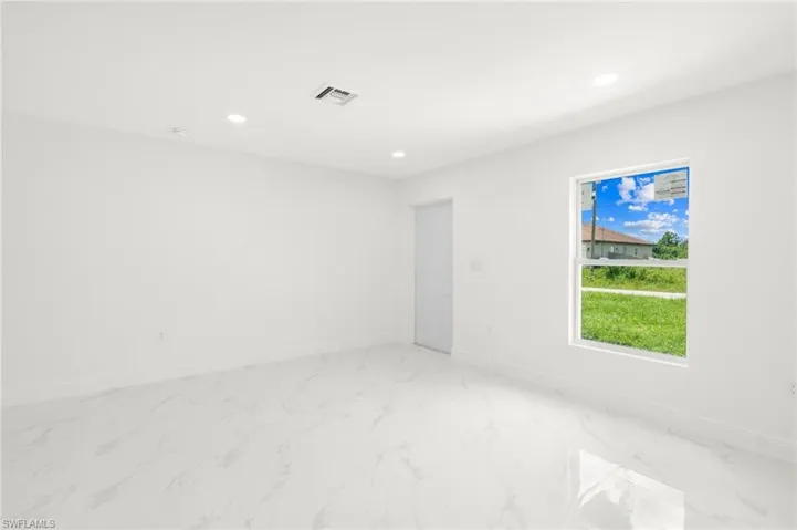 Unfurnished room featuring light tile patterned floors