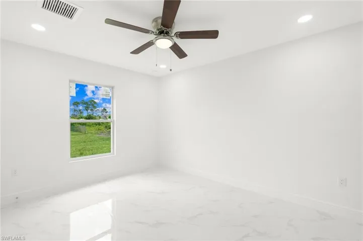 Spare room with ceiling fan and tile patterned flooring