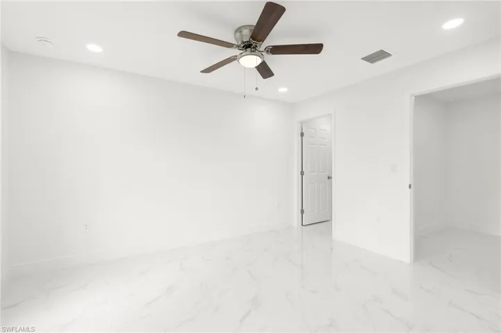 Spare room with light tile patterned floors and ceiling fan