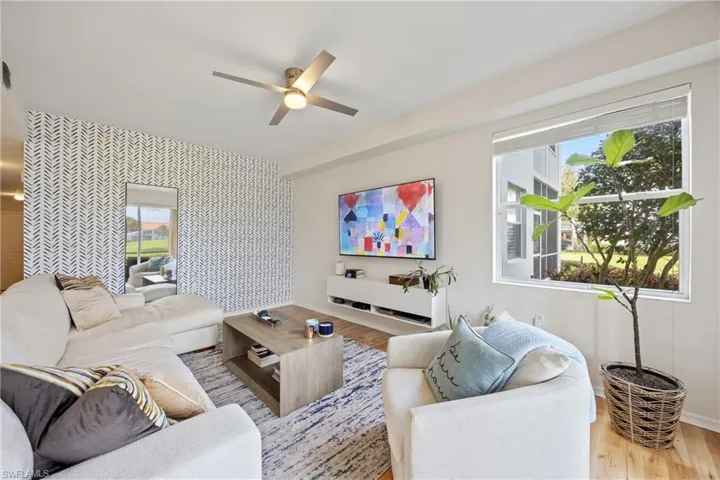 Living room featuring light wood-type flooring and ceiling fan