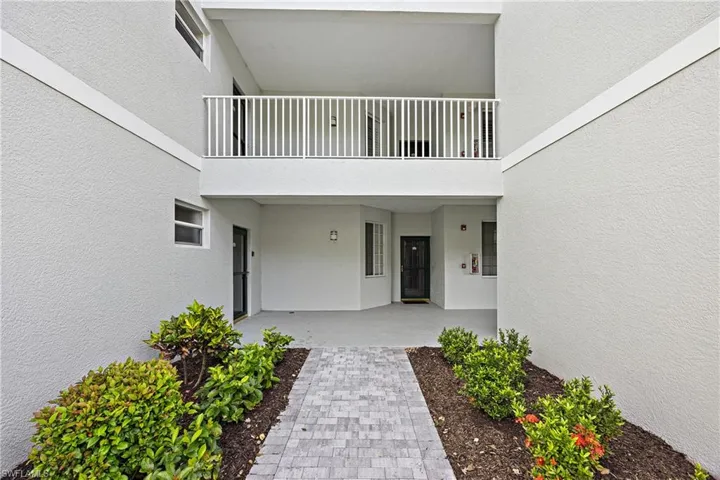 Entrance to property featuring a patio area and a balcony