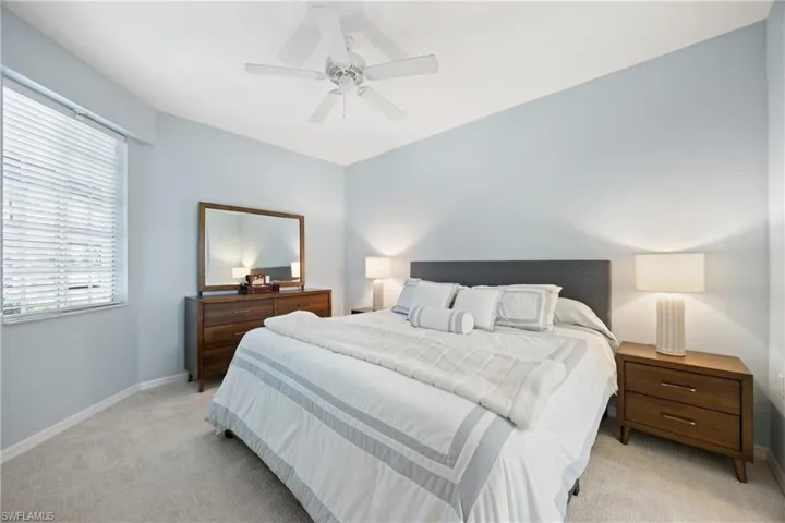 Bedroom featuring light colored carpet and ceiling fan