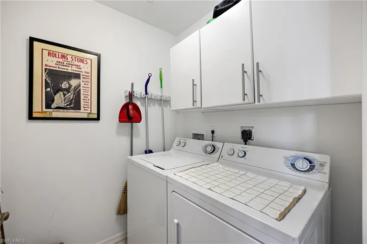 Clothes washing area with cabinets and washing machine and clothes dryer