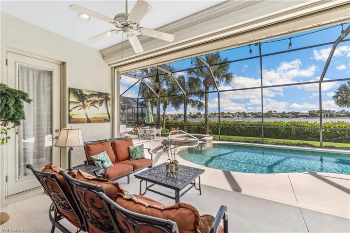 Beautiful pool and patio with a lake view.