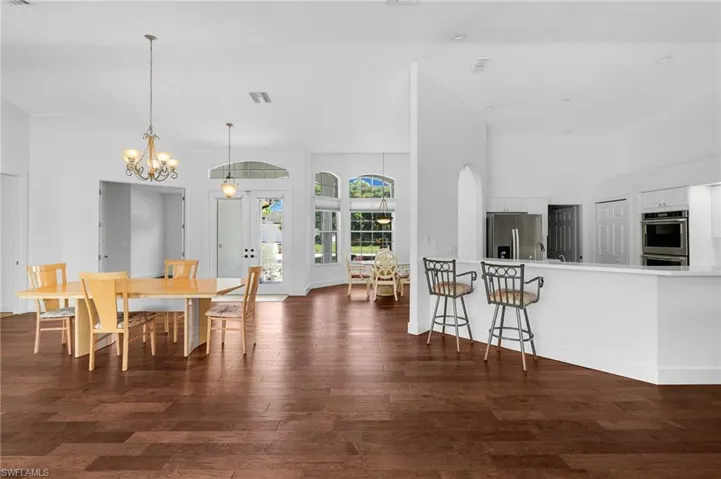 Wood flooring throughout, vaulted ceilings, arched doorways, a breakfast bar.