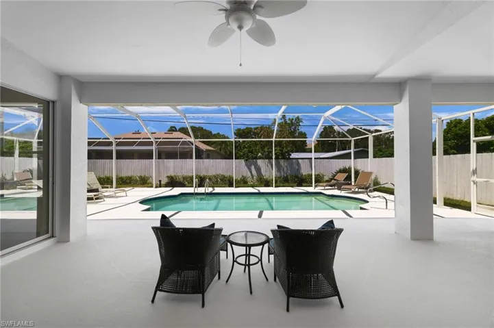Screened-in patio overlooking a private swimming pool—ideal for effortless outdoor relaxing.