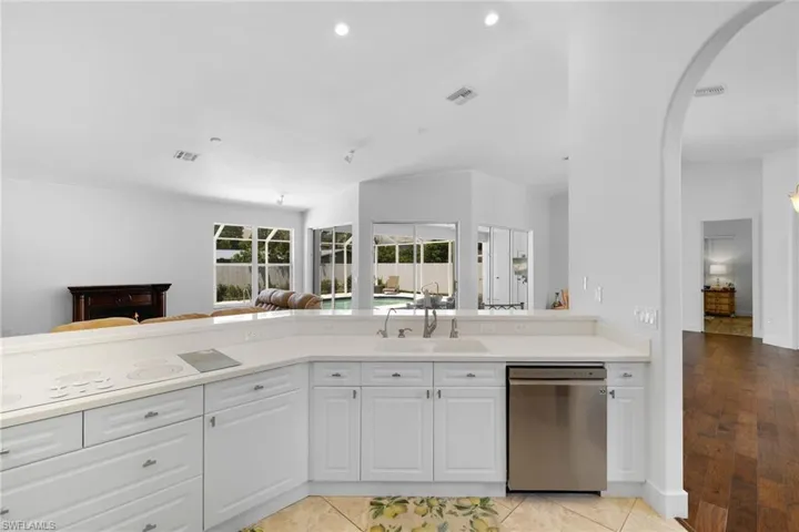 Kitchen with white cabinetry, light countertops, a stainless steel dishwasher and a built-in cooktop