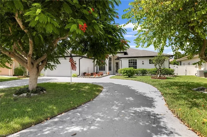 Beautiful landscaped circular driveway leading to front entry.
