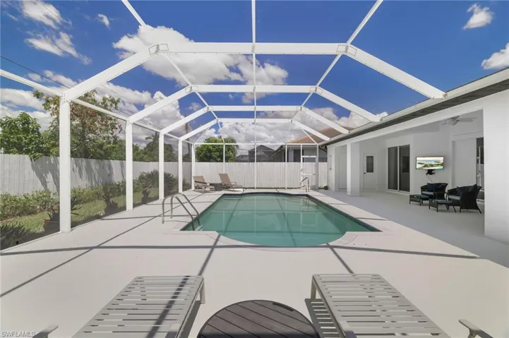 Fully screened pool space offering easy access with built-in entry steps and secure dual handrails.