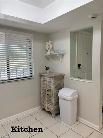 Bathroom featuring baseboards and light tile patterned flooring