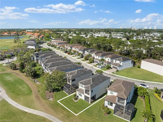 Birds eye view of property with a residential view and a water view