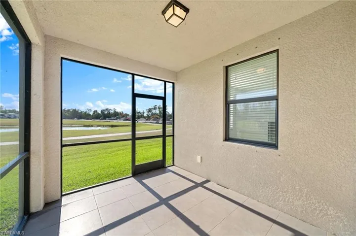 Unfurnished sunroom featuring a water view