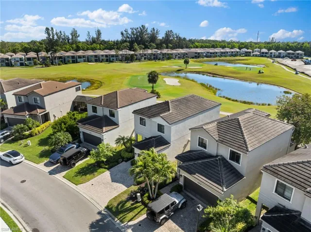 Drone / aerial view featuring a residential view, a water view, and view of golf course