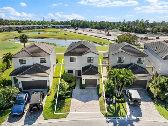 Aerial view with a residential view, golf course view, and a water view