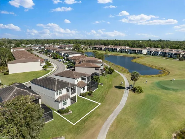 Drone / aerial view with a residential view and a water view