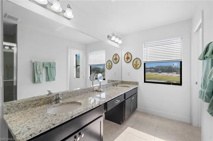 Full bathroom with a sink, plenty of natural light, and tile patterned flooring