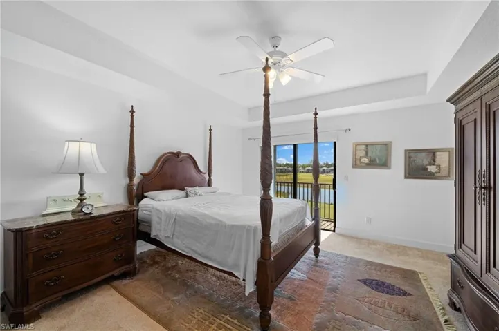 Bedroom with baseboards, light colored carpet, a ceiling fan, and access to outside