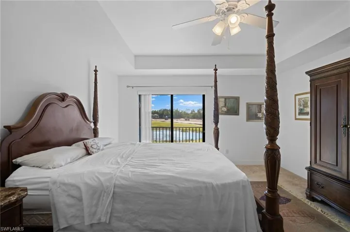 Carpeted bedroom featuring access to exterior, baseboards, and ceiling fan