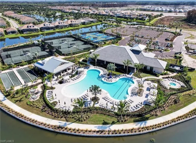 Aerial overview of property's location featuring a nearby body of water and nearby suburban area