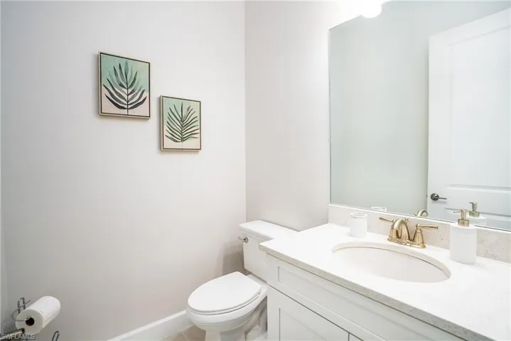 Half bathroom featuring toilet and vanity
