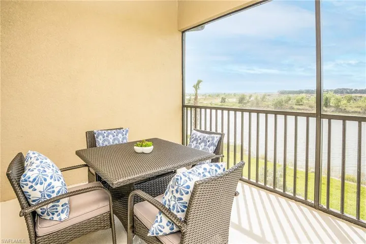 Balcony with a water view and outdoor dining area