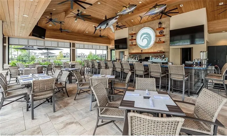 Dining space featuring a wooden ceiling with exposed beams, high vaulted ceiling, and ceiling fan