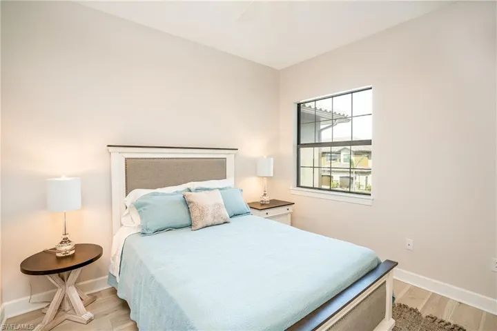 Bedroom with light wood-style floors and a ceiling fan