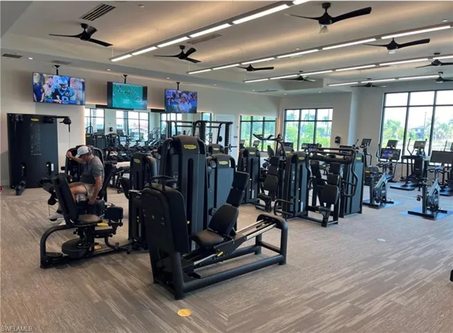 Gym with carpet floors and a ceiling fan